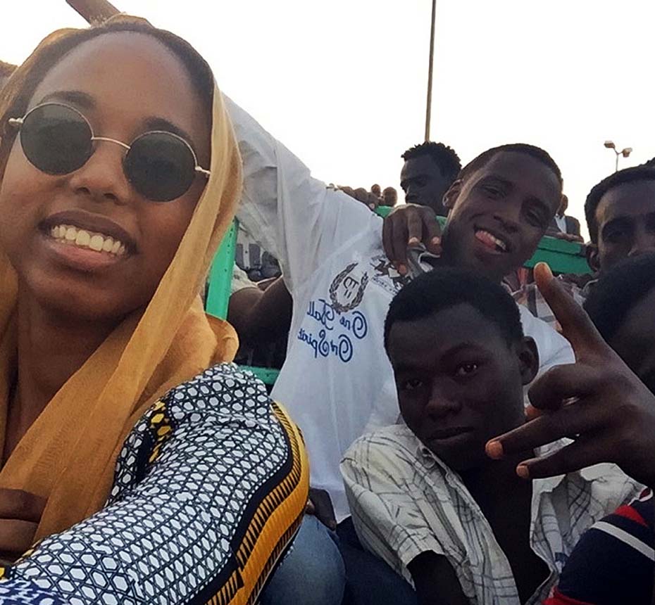Yousra takes a selfie with other spectators in the Nuba wrestling stadium in Khartoum, Sudan
